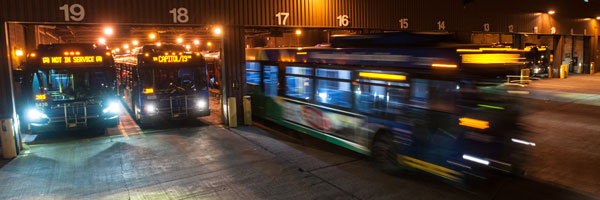 Bus leaving garage at night