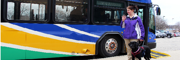 Woman leaving the bus with a service dog