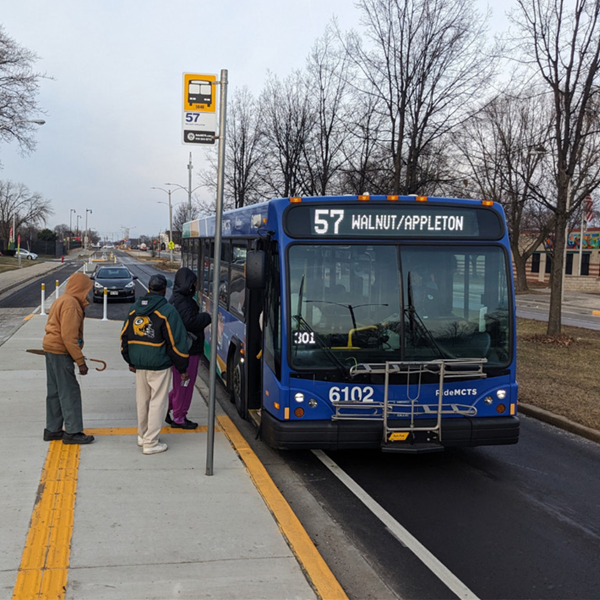Image of individuals boarding an MCTS bus from a bump out bus stop